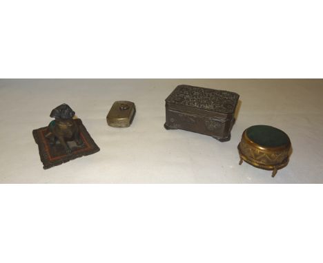 A Bergmann type Pin Cushion in the form of a dog seated on a carpet, a circular brass pin cushion and antimony box and a fold