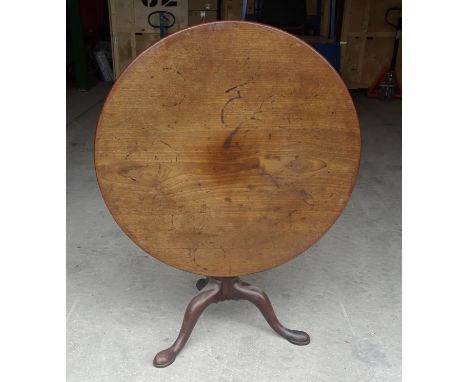 A mid 18th Century mahogany circular tilt top Breakfast Table raised on a bird cage bracket baluster turned column and triple