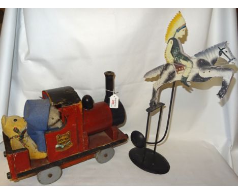 A push along Toy Engine in red and black livery, 15" (38cms) long and a galloping horse toy on a metal stand.