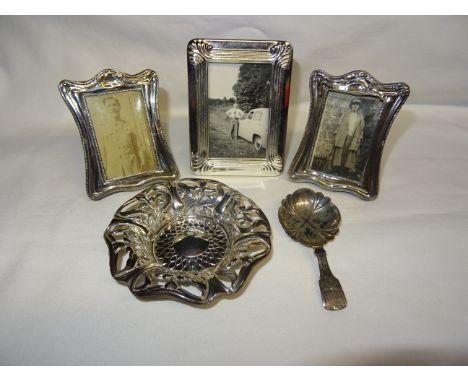 A Victorian silver fiddle pattern Caddy Spoon, a pair of small silver upright table photograph frames, a plated frame and a s