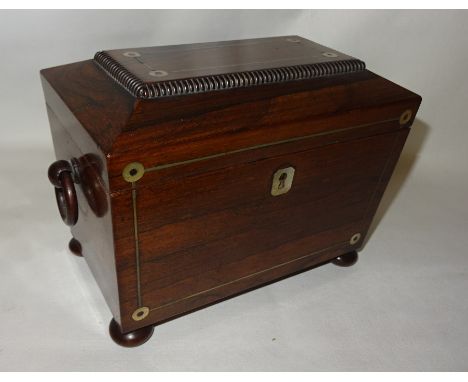 A mid 19th Century rosewood sarcophagus shape Tea Caddy with mother of pearl inlay and ring handles, the interior with two co