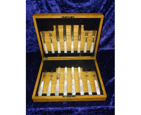 A set of eight silver bladed Dessert Knives and Forks with mother of pearl handles in fitted case, Sheffield, 1938, maker Joh