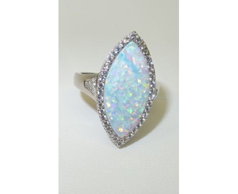 A silver navette shape Dress Ring set with large opal and cubic zirconias.