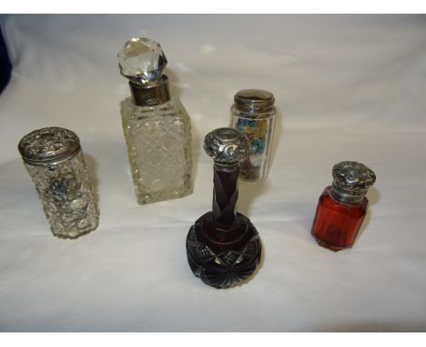 A late Victorian cranberry glass panel sided Scent Bottle with embossed silver cover, a ruby glass scent bottle with silver c