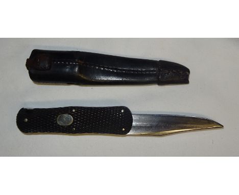 An Army and Navy Stores folding Bowie type Knife with horn grips and leather sheath. 