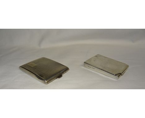 An engine turned silver Matchbook Holder, Birmingham, 1929 and a plain holder, Birmingham, 1930.  (2ozs)