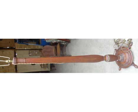 A mahogany Standard Lamp with fluted baluster column and circular base.