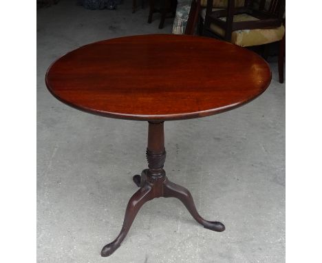 A George III mahogany circular tilt top Occasional Table on a bird cage bracket, baluster turned column and triple splay supp