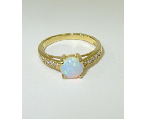 A silver gilt Dress Ring set with a single opal and cubic zirconias.