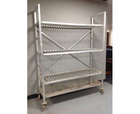 An aluminium four tier trolley / shelf on castors, width 148 cm 