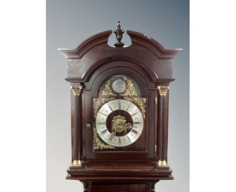 A reproduction mahogany longcase clock with pendulum and weights 