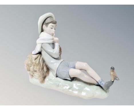 A Lladro figure of a boy with bird 