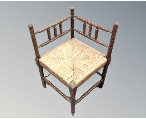 An oak bobbin turned corner chair 
