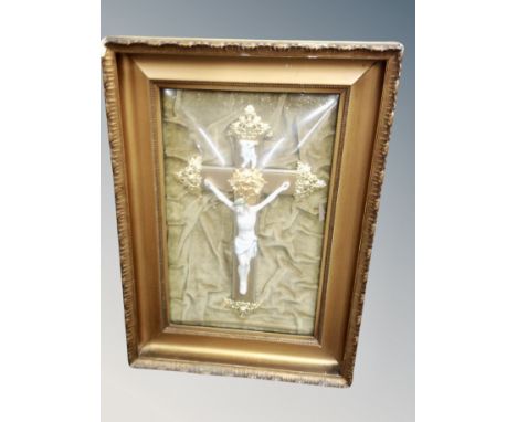 A metal and ceramic crucifix in gilt frame, with convex glass 