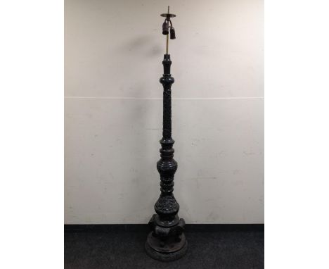A heavily carved Eastern style standard lamp 