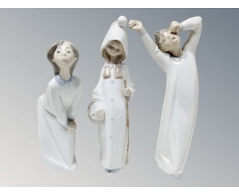 Two Lladro figures of children in nightdress, and one further figure (3)