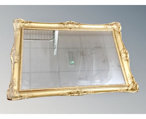 A gilt framed mirror together with a mirrored table lamp 