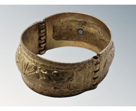 An ornate gilded bangle 