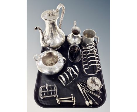 A silver plated three piece tea service, three toast racks, knife rests, loose cutlery etc 