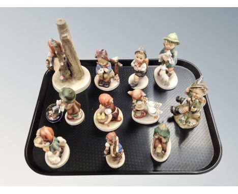 Eleven Goebel figures and a German enamelled tin 
