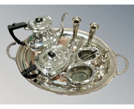 A silver plated twin handled serving tray, diameter 62 cm together with a four piece tea service, pair of candlesticks, pair 