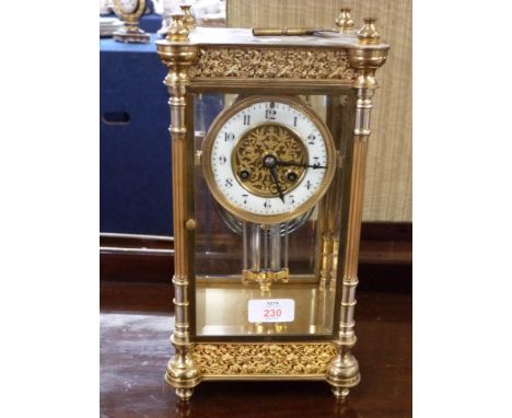 French gilt brass and four glass mounted clock, the circular white enamel face with Arabic numerals to a brass movement strik