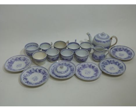 Victorian miniature tea set with blue floral decoration including tea cups and saucers