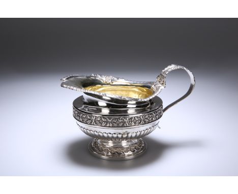 A GEORGE IV SILVER CREAM JUG, PAUL STORR, LONDON 1822, of circular bellied form, the rim chased with shells and gadrooning, w