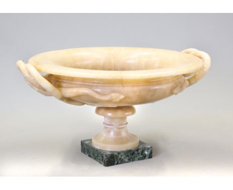 A LARGE 19TH CENTURY ALABASTER URN, circular with entwined serpent handles and everted rim, the turned pedestal raised on a g