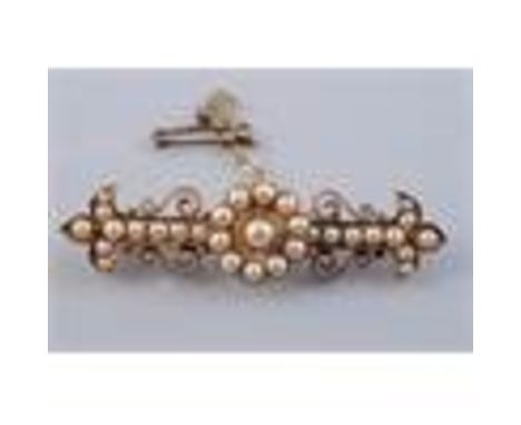 A LATE 19TH CENTURY PEARL SET BROOCH, the central flower head shaped mount set with graduating pearls, on a rectangular brooc