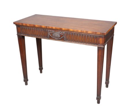 AN ADAM REVIVAL MAHOGANY CONSOLE TABLE, raised on square section tapering legs, the frieze centred by swags. 84cm high, 107cm