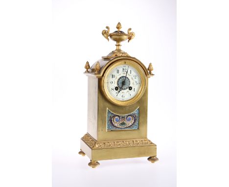 A FRENCH BRASS AND CHAMPLEVE ENAMEL MANTEL CLOCK, C.1900, the dome-top case with urn finial and a further finial to each corn