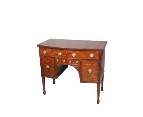 A SMALL REGENCY MAHOGANY BOW-FRONT SIDEBOARD, with an arrangement of drawers and cupboard, fitted with brass urn-backed handl