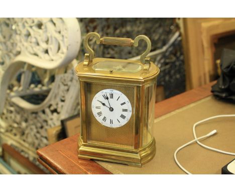 A GILT-BRASS REPEATING CARRIAGE CLOCK, c. 1890, the case with fluted carrying handle and with bowed bevelled glass ends enclo