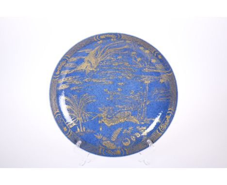 A CHINESE POWDER BLUE AND GILT DISH, circular, painted to the well with a dragon and exotic bird, double ring mark to base. 2