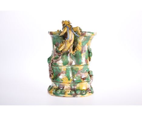 A CHINESE POTTERY VASE IN A SU-SANCAI GLAZE MODELLED WITH A DRAGON, in a mottled glaze of green, yellow and brown, of shaped 