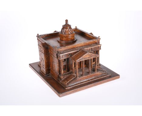A CARVED WOODEN ARCHITECTURAL MODEL OF A RENAISSANCE CHURCH, stained, on a wooden base. 28.5cm by 32cm by 36cm