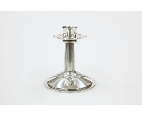 A LIBERTY &amp; CO ENGLISH PEWTER CANDLESTICK, DESIGNED BY ARCHIBALD KNOX, no. 023, the domed base cast with stylised petals 
