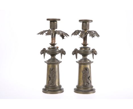 A PAIR OF 19th CENTURY PATINATED METAL CANDLESTICKS IN THE REGENCY TASTE, each with cylindrical candle cup over downscrolled 