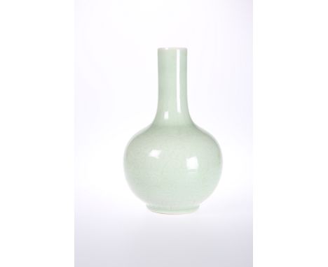 A CHINESE CELADON VASE, bottle shaped, decorated with scrolling foliage and leaves to the neck, bears underglaze blue seal ma