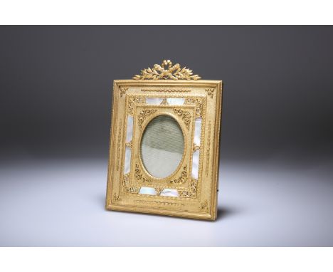 A FINE FRENCH ORMOLU AND MOTHER-OF-PEARL PHOTOGRAPH FRAME, with crest of ribbon tied flaming torches, the rectangular frame w