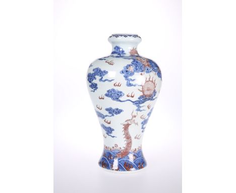 A CHINESE PORCELAIN BALUSTER VASE, painted in blue and aubergine with dragons, masks, flaming pearls and clouds, blue seal ma