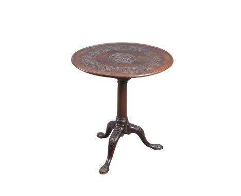 AN 18TH CENTURY MAHOGANY&nbsp;TILT-TOP TRIPOD TABLE, the dished circular top now carved to the centre with a mask and a borde