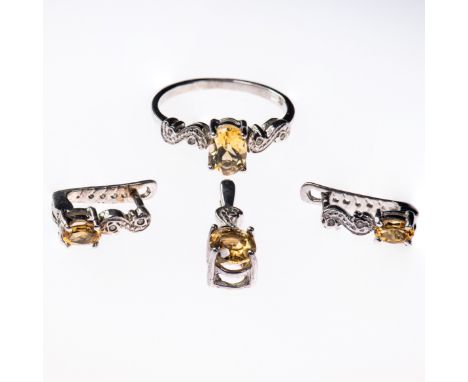 A 9CT WHITE GOLD AND CITRINE RING, the oval cut citrine set between scroll detail shoulders. Ring size P; together with match