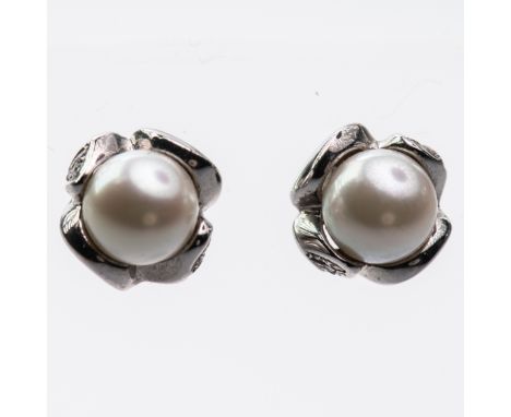 A PAIR OF CULTURED PEARL STUD EARRINGS, the single cultured pearl in heavy moulded mount on post and scroll fittings. Total w