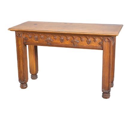 AN ECCLESIASTICAL OAK CONSOLE TABLE, the frieze with Gothic tracery, raised on substantial square section legs. 84cm high, 13