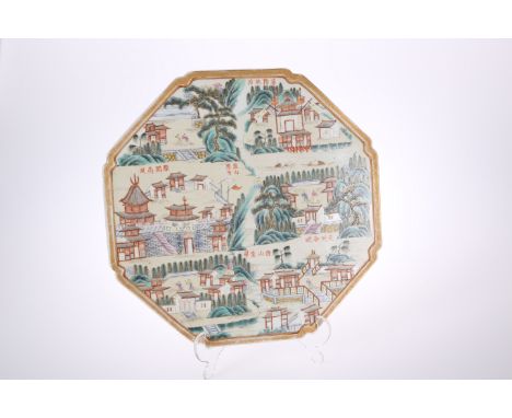 A CHINESE PORCELAIN TILE OR PANEL IN A FAMILLE ROSE PALETTE, octagonal, decorated with a city or townscape, trees and calligr