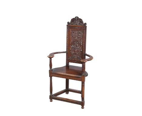 A 17TH CENTURY STYLE OAK ARMCHAIR, 19TH CENTURY, the back carved with a roundel containing a portrait of a gentleman, the sad