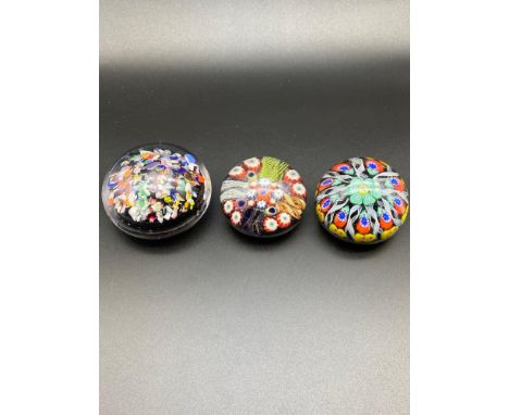 Three vintage art glass Scottish paperweights. 