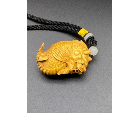 A Japanese hand carved netsuke of a Dragon fish [5cm in length] 